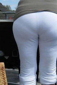 Large, bodacious woman sensuously taking off her lingerie